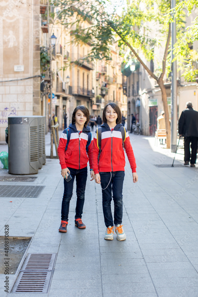 Obraz premium Cute little children tourists admiring Barcelona city, family travel with kids