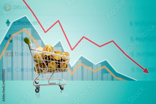 Cryptocurrency coins on trolley with declining arrow