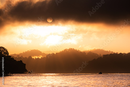 Beautiful morning scenery at a lake with warm colors of the sunrise