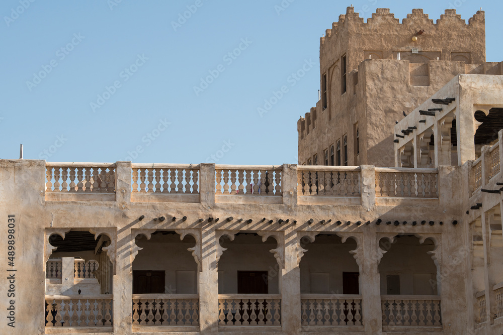 
Doha, Qatar, May,6,2019, Traditional Arabian building built of wood and mud decorated with a facade in the traditional Arabic style.