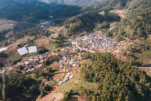 Aerial view of local rural village in the valley on faraway at countryside among the tropical rainforest