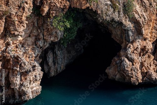sea cave in the rocks above the water