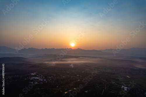 aerial view 4K Time lapse of Majestic sunset or sunrise landscape Amazing light of nature cloudscape sky and Clouds moving away rolling with mountain in thailand and earth day concept