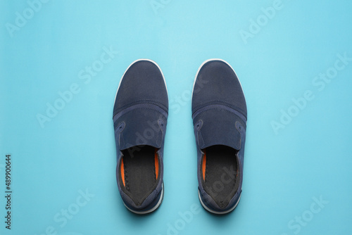 Top view of Casual shoes on blue color background.