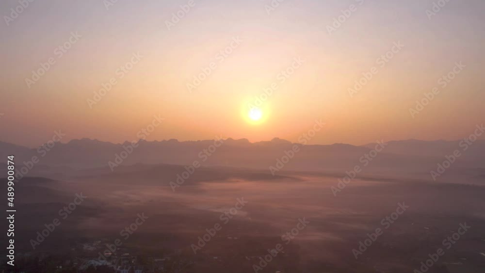 aerial view 4K Time lapse of Majestic sunset or sunrise landscape Amazing light of nature cloudscape sky and Clouds moving away rolling with mountain in thailand