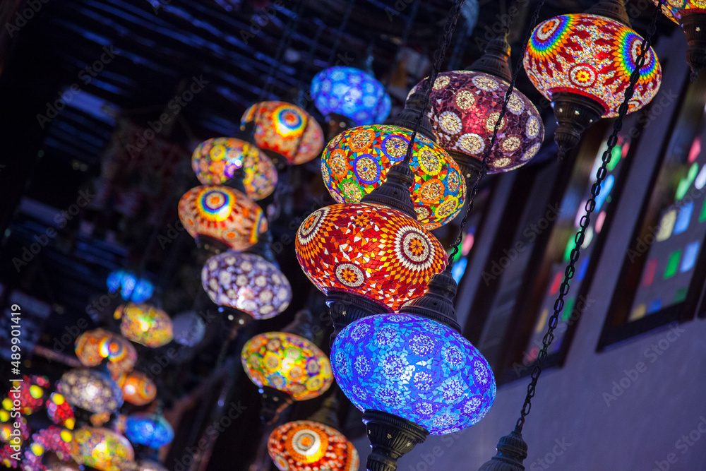Doha,Qatar-May 05 2019: In the Old market Souk Waqif a decorative, traditional, glass mosaic lamps hanging. 