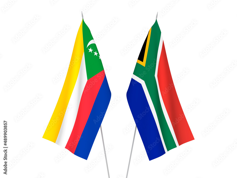 National fabric flags of Republic of South Africa and Union of the Comoros isolated on white background. 3d rendering illustration. National fabric flags of Republic of South Africa and Union of the Comoros isolated on white background. 3d rendering illustration.