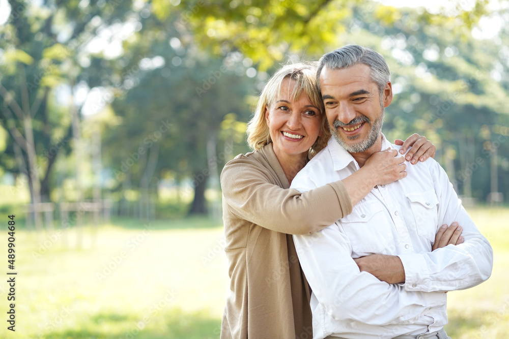 Portrait of happy elderly couple hug together take care and love with good relationship good health and romantic in the park retirement insurance and lovely couple concept Portrait of happy elderly couple hug together take care and love with good relationship good health and romantic in the park retirement insurance and lovely couple concept