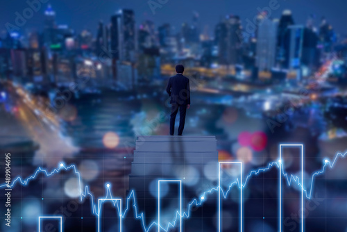 Confidential businessman wearing suit standing on stair with a big city in the background, development and leader in business concept.