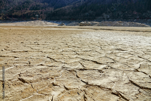 Climate change. Large mountain lake completely drained by drought. Ceresole Reale, Italy - February 2022