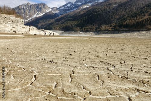 Climate change. Large mountain lake completely drained by drought. Ceresole Reale, Italy - February 2022