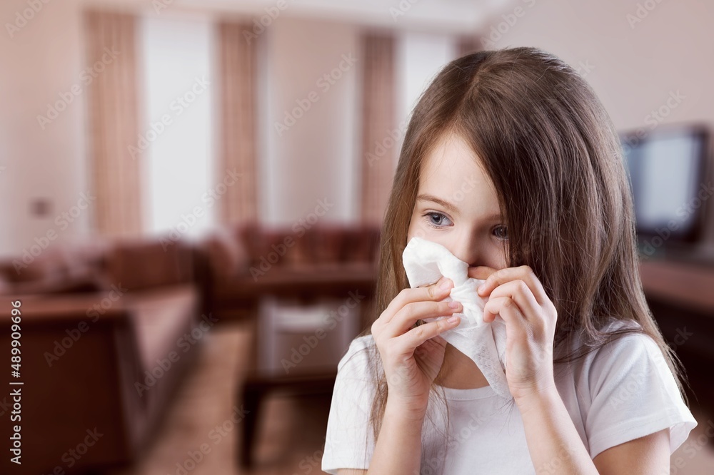 Young kid feels unwell, blows nose in tissue, suffers from running nose, cold symptoms or allergy Young kid feels unwell, blows nose in tissue, suffers from running nose, cold symptoms or allergy