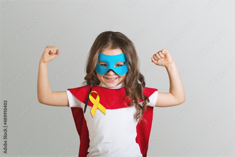 Φωτογραφία World Childhood cancer Day.  Girl in superhero costume posing