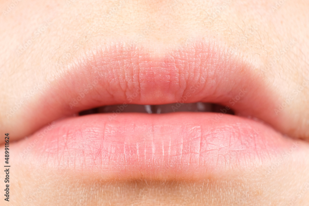 Fototapeta premium Human female lips close-up, macro photography, natural, no makeup.