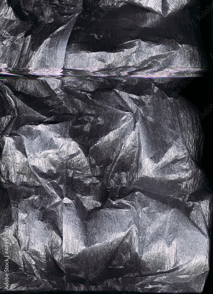 Grunge overlay. Crushed foil texture. Rough crumpled paper. Silver gray white shiny wrinkled distressed metallic old film with scratches on dark black abstract background. Grunge overlay. Crushed foil texture. Rough crumpled paper. Silver gray white shiny wrinkled distressed metallic old film with scratches on dark black abstract background.