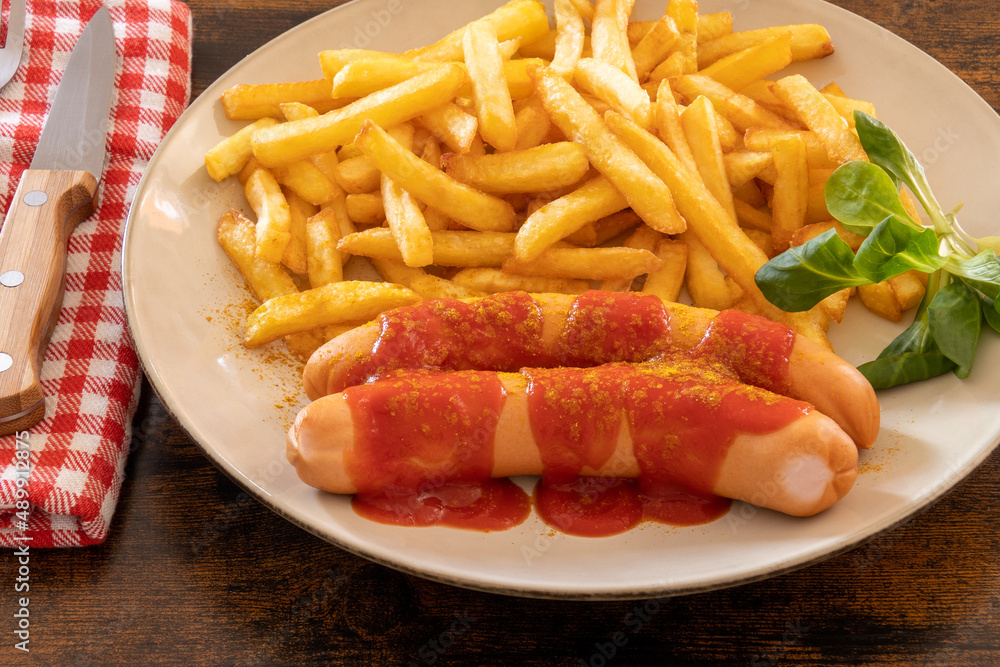 top view of a cervelas curry wurst on a plate with fries top view of a cervelas curry wurst on a plate with fries