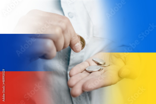 Business finance saving and investment concept. Woman holding silvery coins in her hand. International political relationship between Ukraine and Russia.