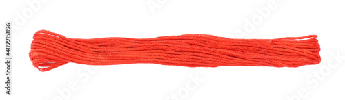 Bright coral embroidery thread on white background