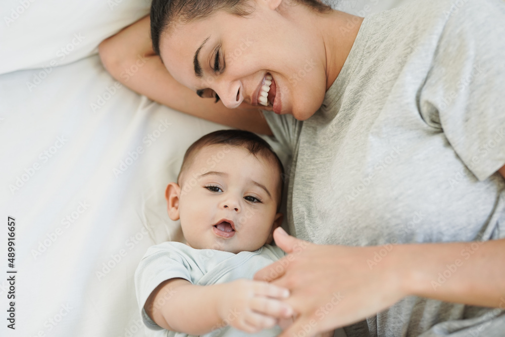 Loving mother having tender moment with 6 months old baby in the morning Loving mother having tender moment with 6 months old baby in the morning