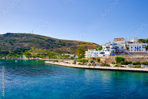 Beautiful summer day, sunshine in typical town of Greek island. Whitewashed houses on hills. Mediterranean vacations. Milos, Cyclades, Greece.
