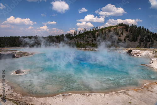 Geyser steam rises from Excelsior Geyser in Yellowstone National Park.
