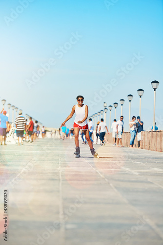 The best way to start the day. Shot of an attractive young woman rollerblading on a boardwalk.
