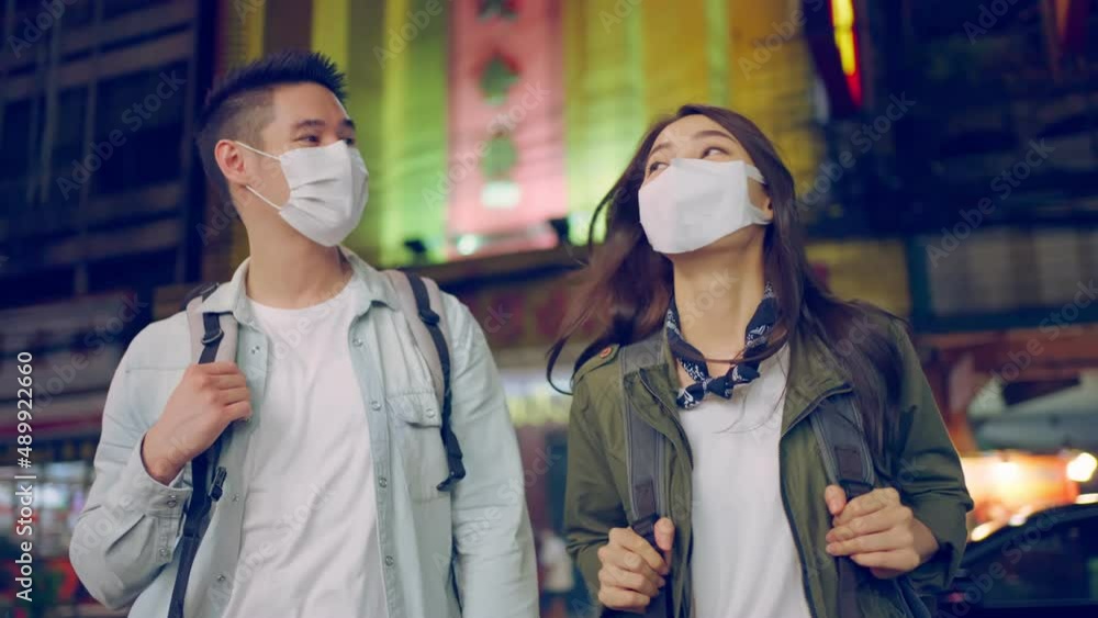 Asian attractive couple travel in the city for honeymoon trip at night Asian attractive couple travel in the city for honeymoon trip at night