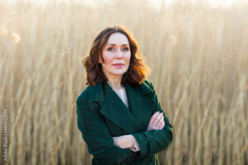 portrait of middle aged woman posing at the park