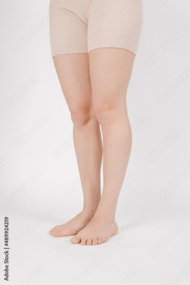 Barefoot and legs isolated on white background. Closeup shot of healthy beautiful female feet. Health and beauty concept. Side view of human foot ream with neutral manicure or pedicure. Sole of foot Barefoot and legs isolated on white background. Closeup shot of healthy beautiful female feet. Health and beauty concept. Side view of human foot ream with neutral manicure or pedicure. Sole of foot