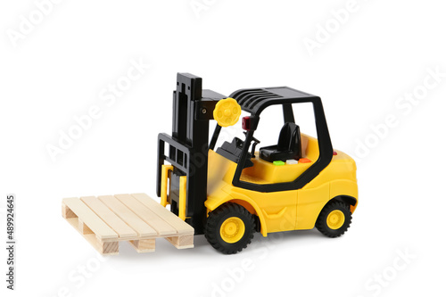 Toy forklift with wooden pallet on white background