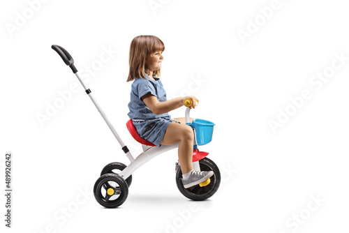 Profile shot of a girl riding a tricycle