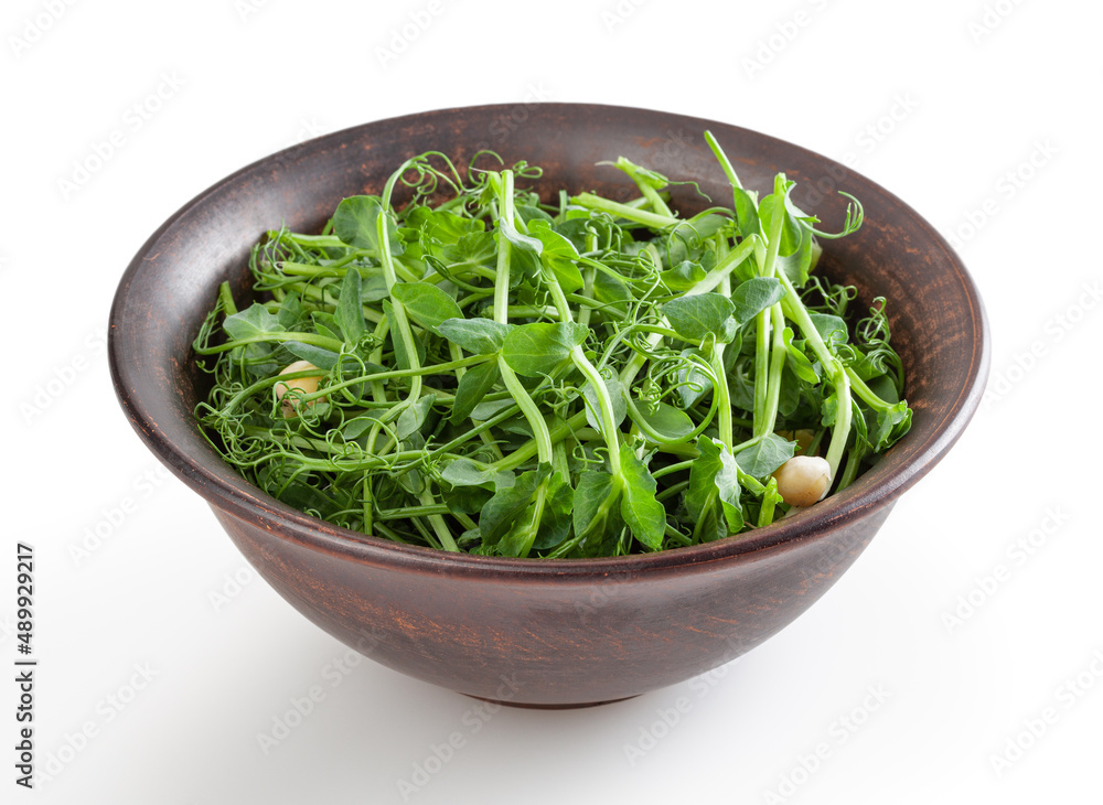 Fresh microgreens of pea in ceramic bowl isolated on white background with clipping path Fresh microgreens of pea in ceramic bowl isolated on white background with clipping path
