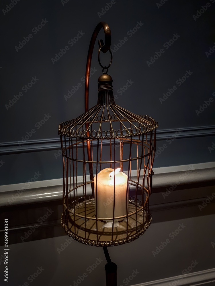 Candle Burning in a Cage in an Old House