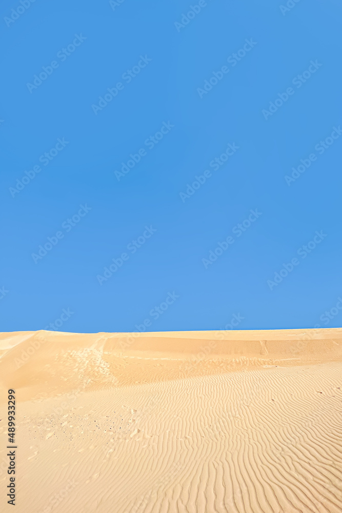 Blue sky and yellow sand desert nature background. Creative idea of Ukraine flag. Copy space background. World peace concept.