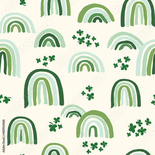 Vector repeat pattern with green tone rainbows and shamrock on cream background. Great for Irish holiday St Patricks Day and spring projects © Pattern_Talent