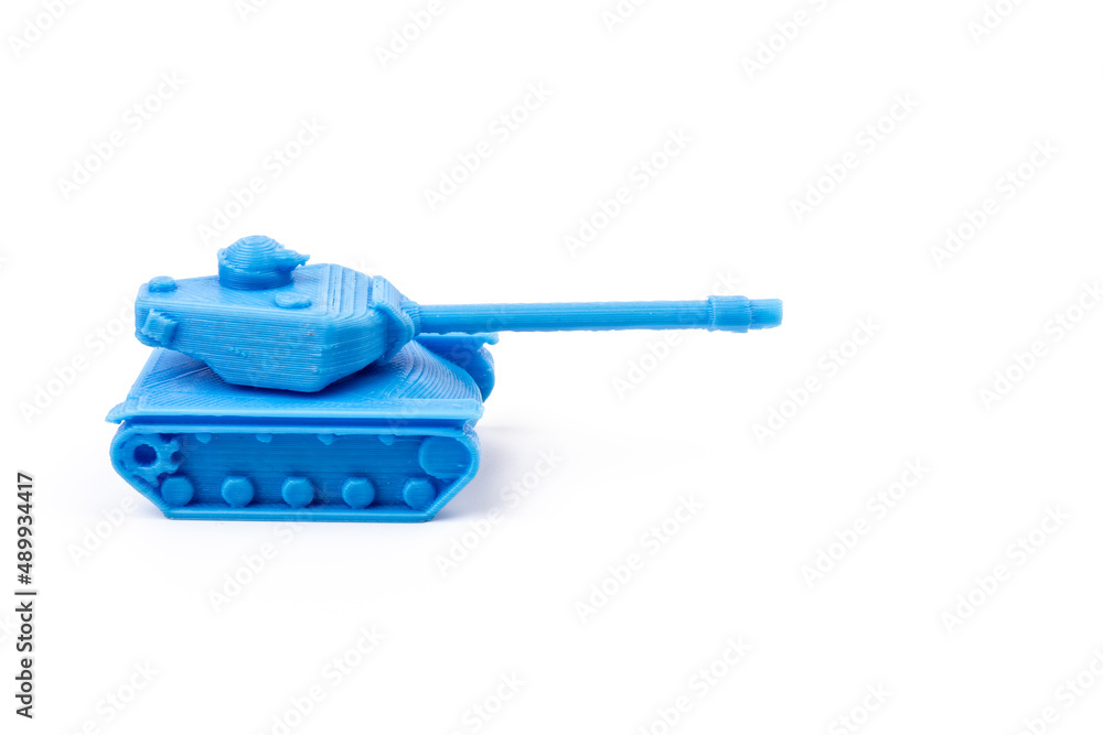 Toy tank of blue color. Close-up of little plastic ABS model. Blue filament. Objects printed by 3d printer Isolated on white background. Toy tank of blue color. Close-up of little plastic ABS model. Blue filament. Objects printed by 3d printer Isolated on white background.