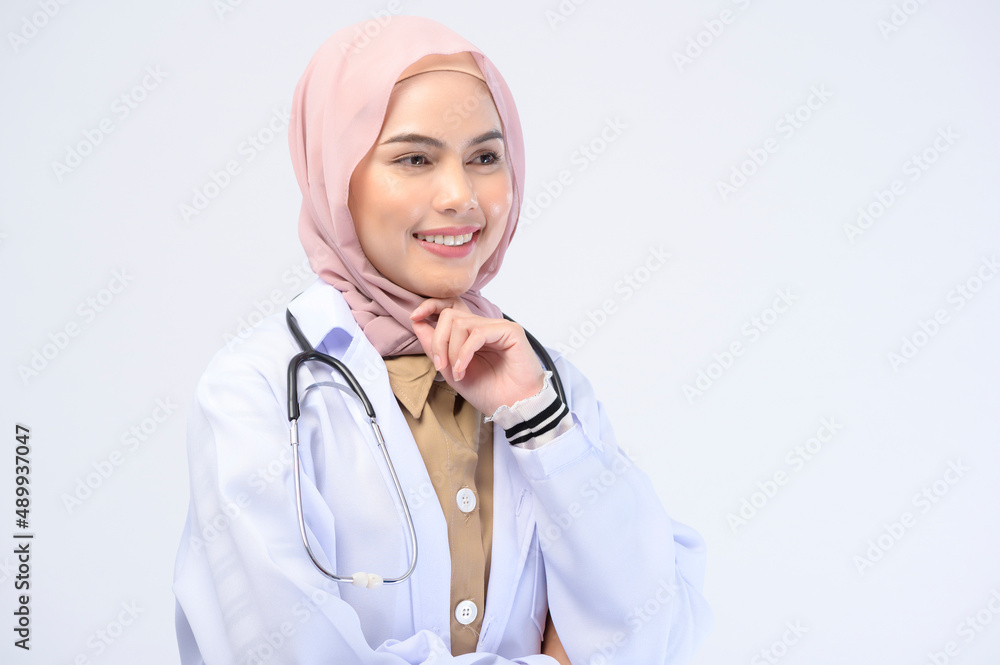 Female muslim doctor with hijab over white background studio. Female muslim doctor with hijab over white background studio.