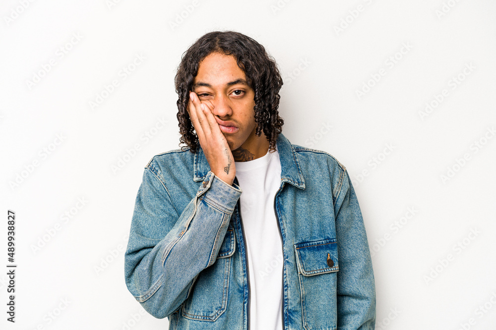 Young African American man isolated on white background who is bored, fatigued and need a relax day. Young African American man isolated on white background who is bored, fatigued and need a relax day.