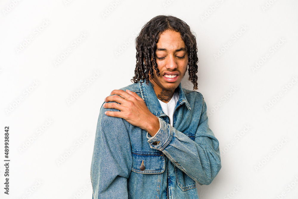 Young African American man isolated on white background having a shoulder pain. Young African American man isolated on white background having a shoulder pain.
