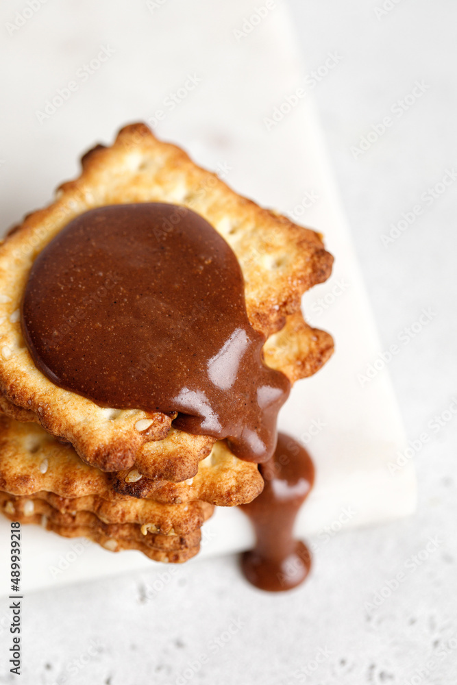 Crackers or cookies with chocolate paste pouring down. Food porn ...