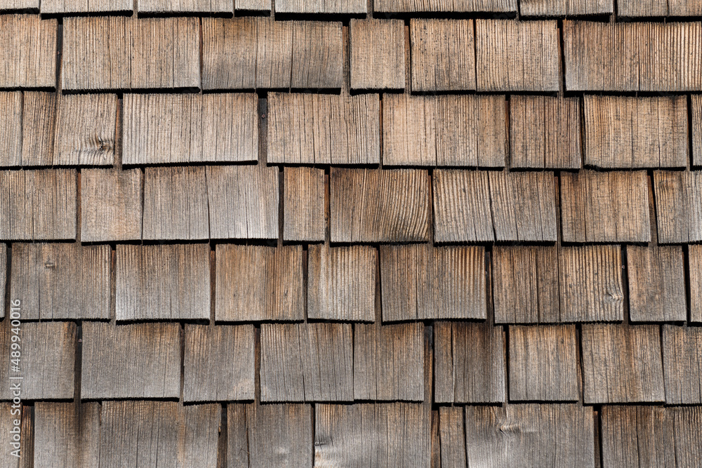 Verwitterte Holzschindeln an einer Hausfassade.
Verwitterte Holzschindeln an einer Hausfassade.