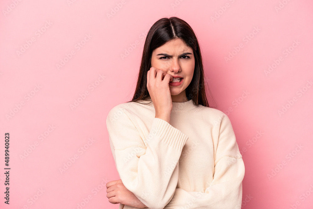 Young caucasian woman isolated on pink background biting fingernails, nervous and very anxious. Young caucasian woman isolated on pink background biting fingernails, nervous and very anxious.