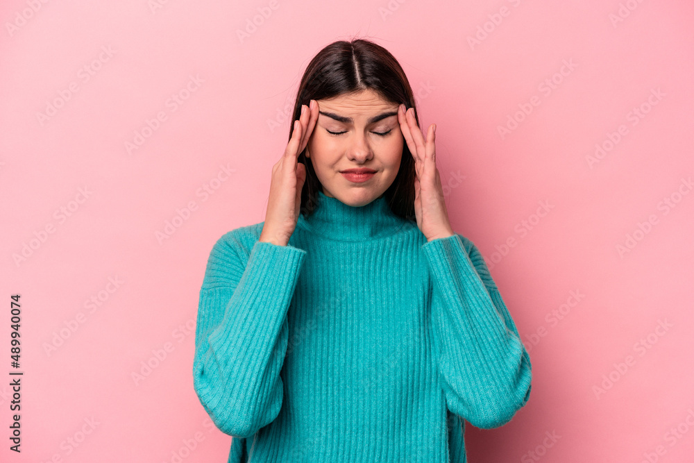 Young caucasian woman isolated on pink background touching temples and having headache. Young caucasian woman isolated on pink background touching temples and having headache.