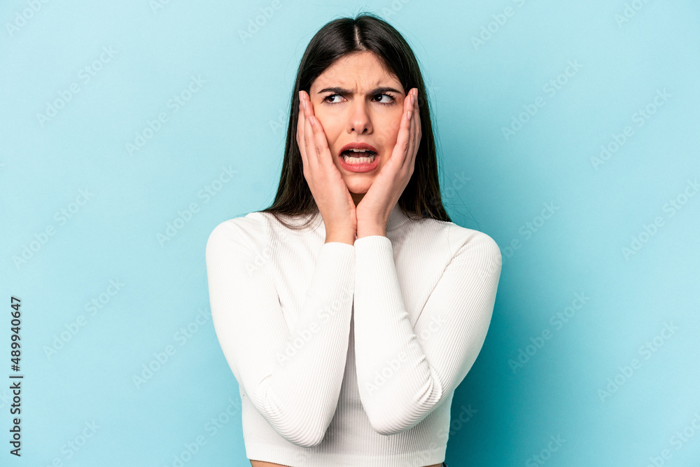 Young caucasian woman isolated on blue background scared and afraid. Young caucasian woman isolated on blue background scared and afraid.