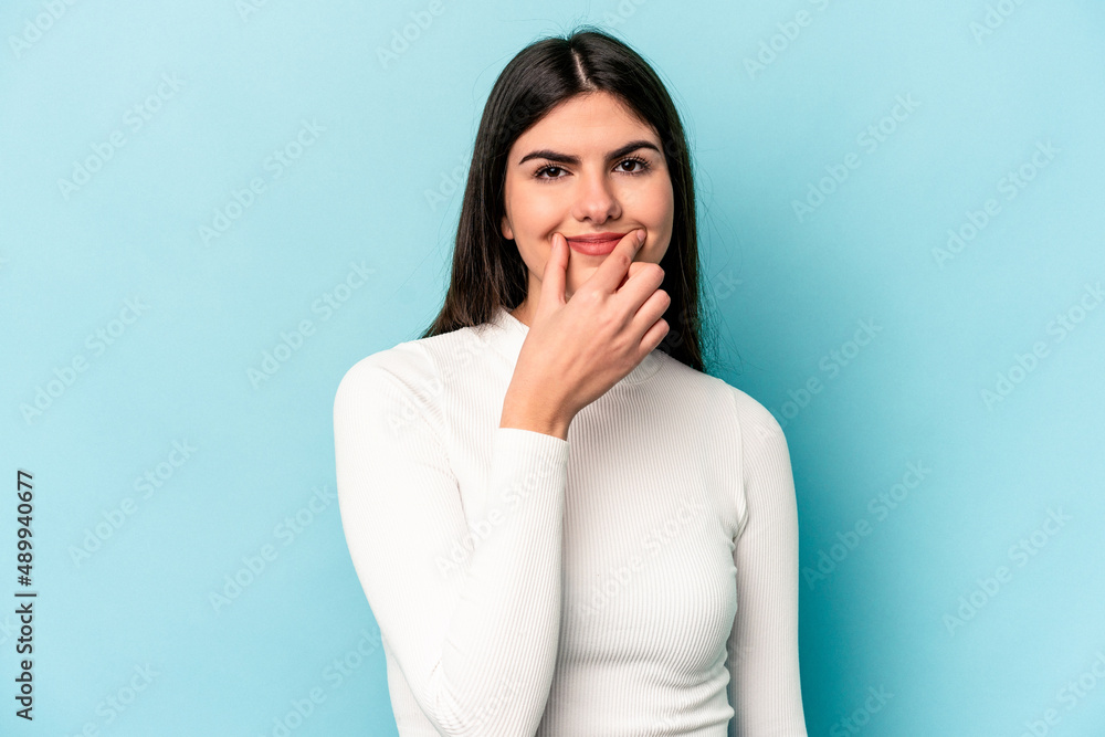 Young caucasian woman isolated on blue background doubting between two options. Young caucasian woman isolated on blue background doubting between two options.