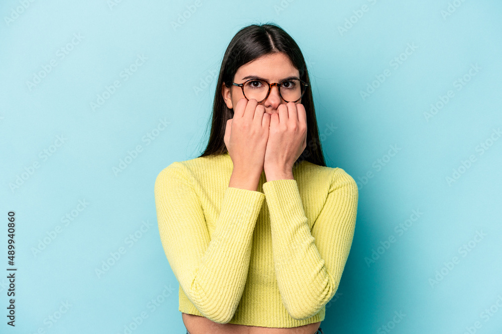 Young caucasian woman isolated on blue background biting fingernails, nervous and very anxious. Young caucasian woman isolated on blue background biting fingernails, nervous and very anxious.