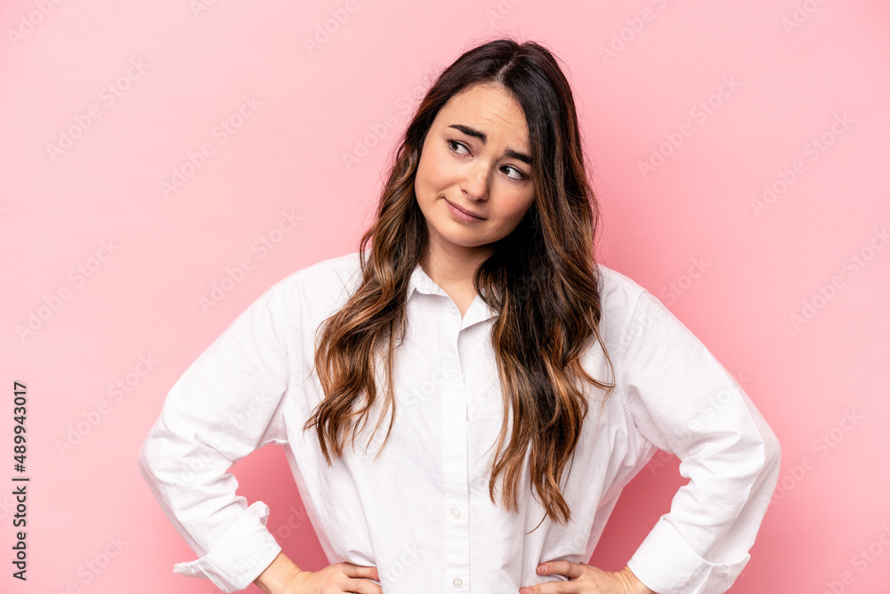 Young caucasian woman isolated on pink background confused, feels doubtful and unsure. Young caucasian woman isolated on pink background confused, feels doubtful and unsure.