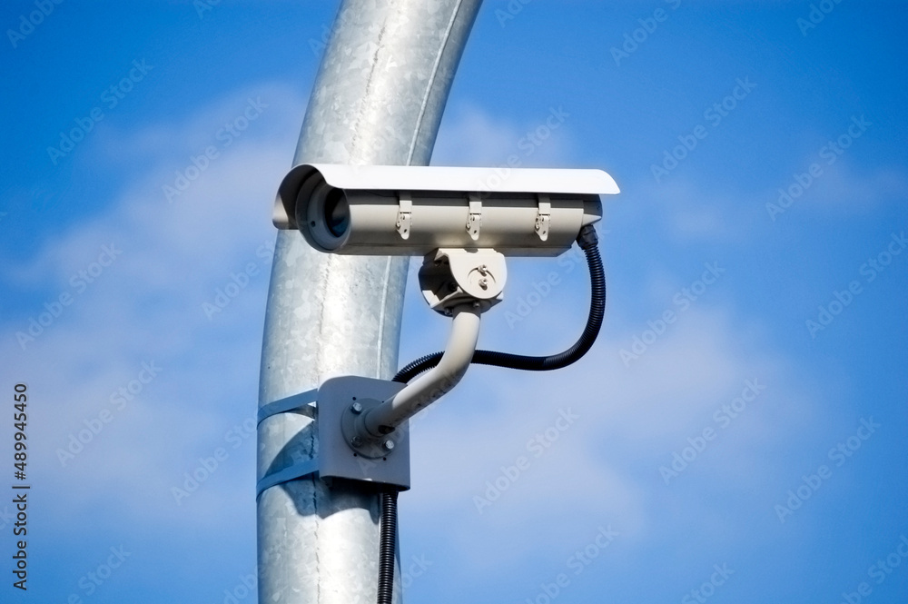 City monitoring system camera against blue sky. City monitoring system camera against blue sky.