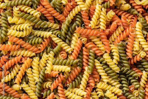 Three colors fusilli pasta. Colorful italian raw pasta.