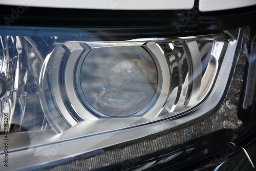 New headlight of a modern car close up. Photo can be used as a background © kalichka